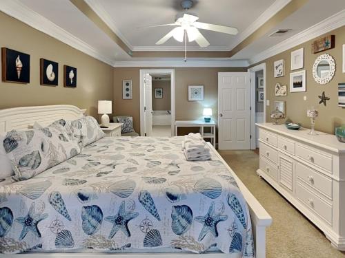 a bedroom with a bed and a ceiling fan at Brass Rail 303 in Tybee Island