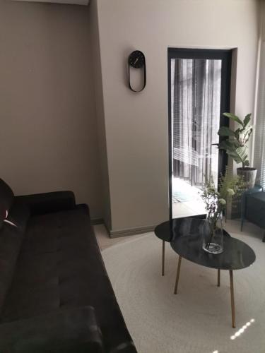 a living room with a couch and a table and a mirror at The Centurion Sunset in Centurion