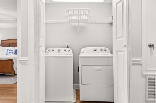 a kitchen with two white appliances in a room at Brass Rail 220 in Tybee Island
