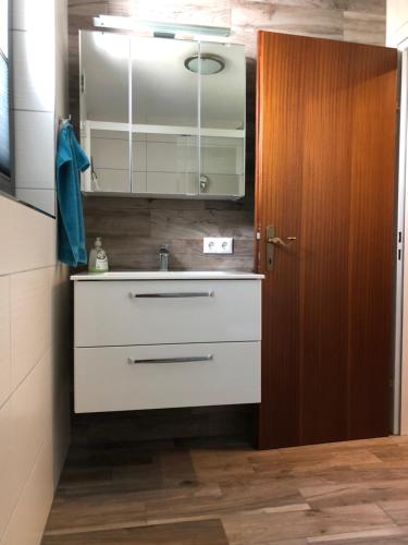 a bathroom with a white sink and a mirror at appartement Landhaus Osttirol in Iselsberg