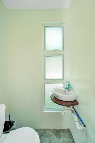 a bathroom with a sink and a window at Corten Villa - A Vacation within Your Vacation in Saint Georgeʼs