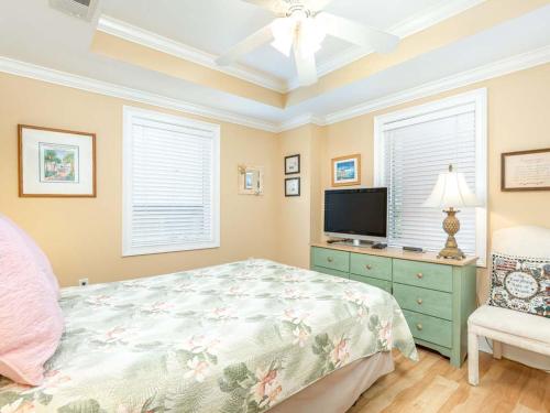 a bedroom with a bed and a flat screen tv at Brass Rail 214 in Tybee Island