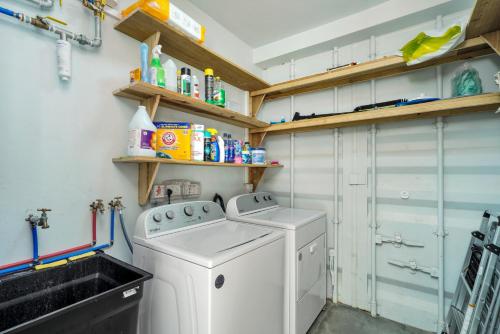 a small laundry room with a washer and dryer at Corten Villa - A Vacation within Your Vacation in Saint Georgeʼs