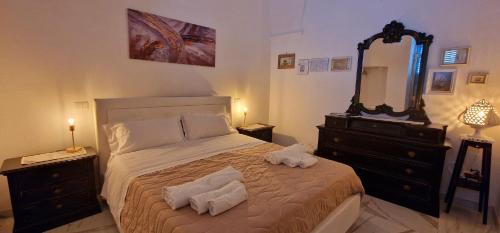a bedroom with a bed and a dresser and a mirror at La Corte dei Sarti in Copertino