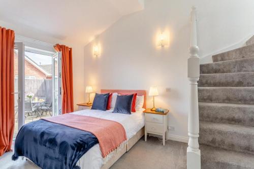 a bedroom with a bed with blue and red pillows at 2 Bed in Church Fenton oc-m30985 in Church Fenton