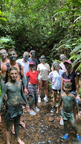 a group of people standing in a stream in the woods at Hostal La Esmeralda in El Valle