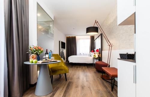 a hotel room with a table and a bed at NYX Hotel Bilbao by Leonardo Hotels in Bilbao