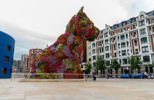 a large sculpture of a dog covered in flowers at NYX Hotel Bilbao by Leonardo Hotels in Bilbao