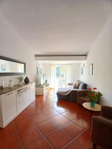 a bedroom with a bed and a living room at casa de ferias in Algoz