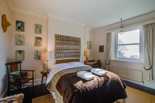 a bedroom with a bed with two towels on it at 6 Bed in Branscombe oc-jbetco in Branscombe