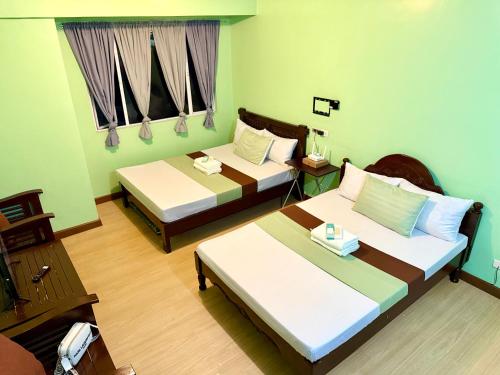 a hotel room with two beds in a room at Albergo Hotel - Studio Condo Unit - Baguio Transient in Baguio