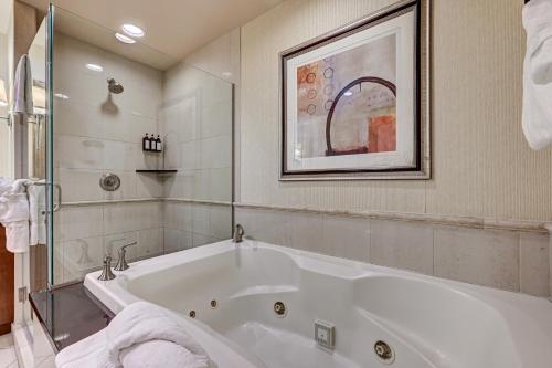 a bathroom with a large white bath tub at MGM SIGNATURE - Strip View Suite- FREE valet parking in Las Vegas