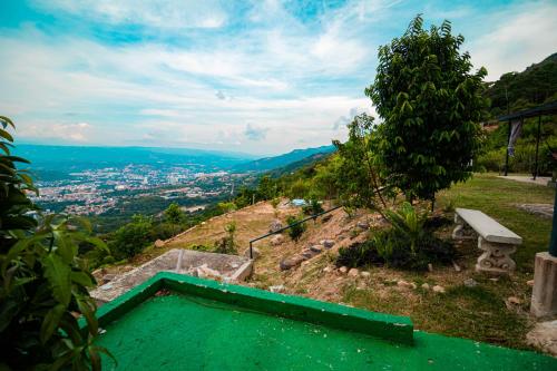 a swimming pool on top of a hill with a bench at GREEN APARTMENT "el bosque" in Girón