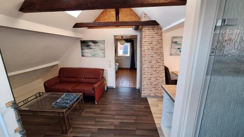 a living room with a couch and a table at Cozy apartment with S-Bahn connection to Frankfurt in Rödermark