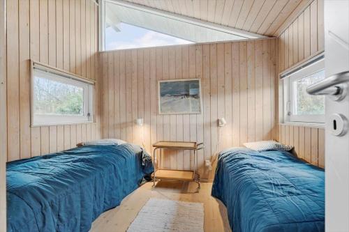 a bedroom with two beds and a window at 6803-Allinge-Asbakken-20 in Allinge