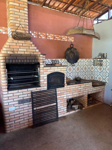 a kitchen with a brick oven in a room at Rancho PR in Brasilia