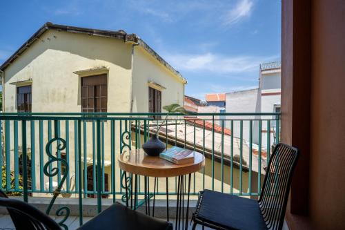 a balcony with a table and chairs and a building at Tropical An Bang Beach Villa in Hoi An