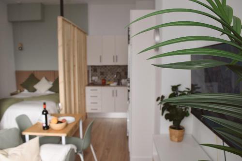 a living room with a bed and a table with a plant at Brisa del Mar in Tacoronte