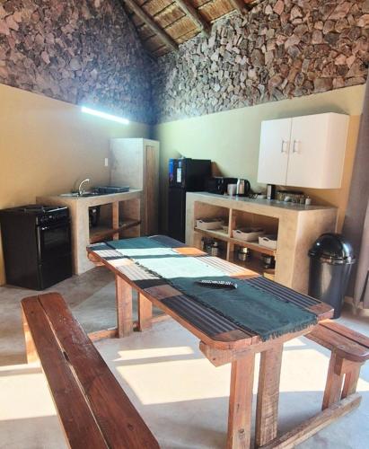 a kitchen with a wooden table in a room at Hide Away Wedding,Conference & Function Venue in Bela-Bela