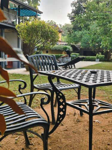 a group of benches sitting in a park at Honey Tree Polonnaruwa in Polonnaruwa