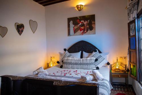 a bedroom with a bed with towels on it at Dar Lalamoune in Fès