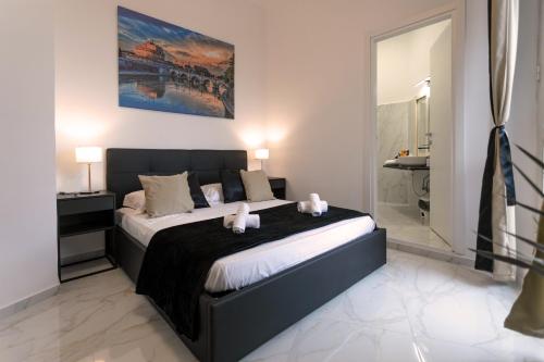 a bedroom with a large bed and a bathroom at Re di Roma Rooftop in Rome