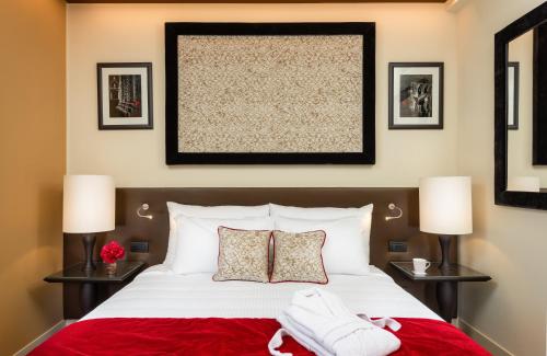 a bedroom with a large bed with a red blanket at Leonardo Royal Hotel Venice Mestre in Mestre