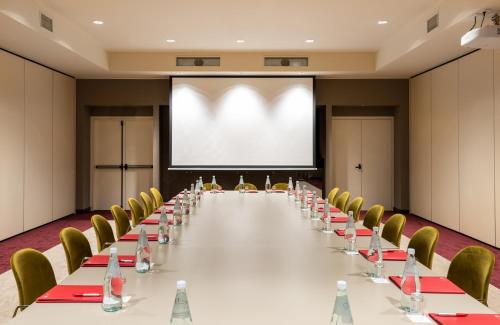 a large conference room with a long table and chairs at Leonardo Royal Hotel Venice Mestre in Mestre