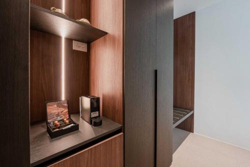 a room with a fireplace in a wooden cabinet at Muse οf Mykonos Luxury Suites in Mýkonos City