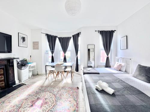 a living room with a bed and a dining room at Westfield London Shepherds Bush in London