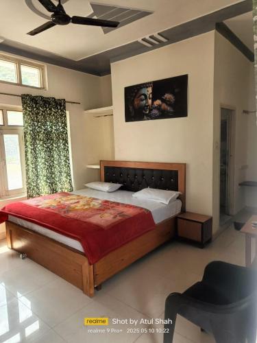 a bedroom with a large bed and a ceiling fan at Hotel Ajay Palace in Pīpalkoti