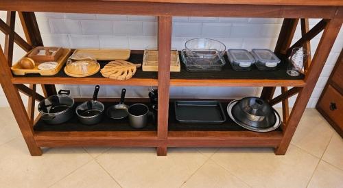 a shelf with food and utensils on it at CASA OURO até seis pessoas com conforto pertim do Centro Histórico in Tiradentes