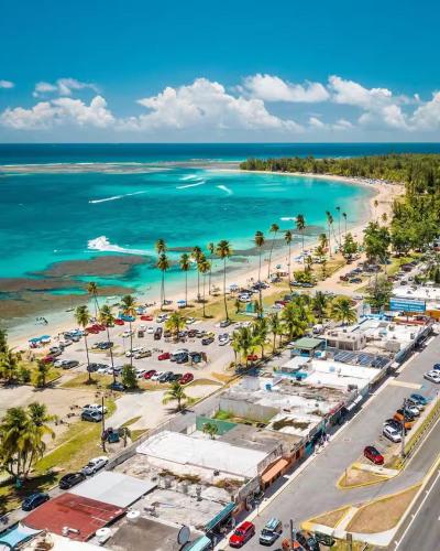 an aerial view of a beach with a parking lot at Relax San Juan in San Juan