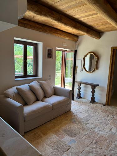 a living room with a couch and a table at Le Tre Aie in San Giovanni a Piro