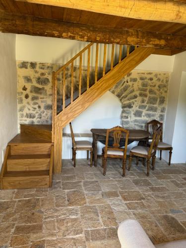 a dining room with a table and chairs and a staircase at Le Tre Aie in San Giovanni a Piro