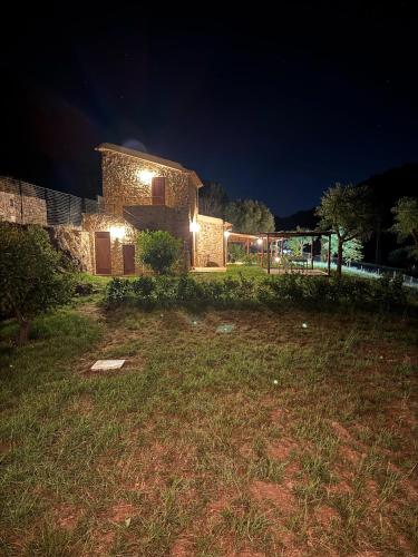 a stone house at night with lights on it at Le Tre Aie in San Giovanni a Piro