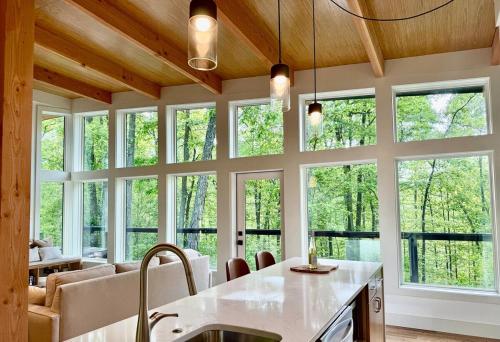 a kitchen with a large group of windows at The Briar House in McArthur