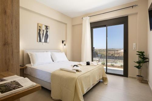 a bedroom with a bed and a large window at Emmanouil Private Villa A in Roumelí