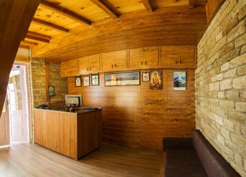 a room with a counter and a brick wall at Kasar Rainbow Yoga Retreat in Hawālbāgh