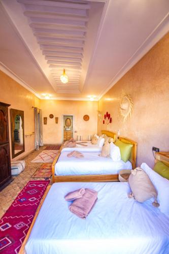 a hotel room with two beds with towels on them at KOUTOBIA ROYAL in Marrakech