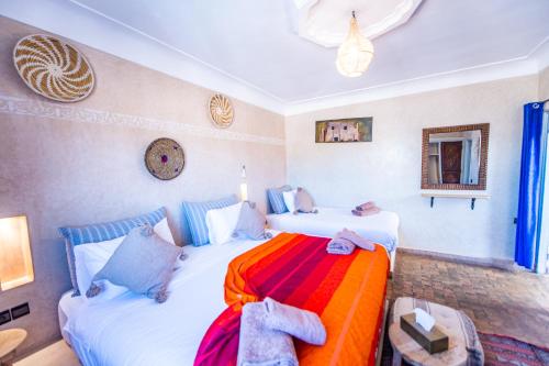 two beds in a room with two beds sidx sidx sidx at KOUTOBIA ROYAL in Marrakech