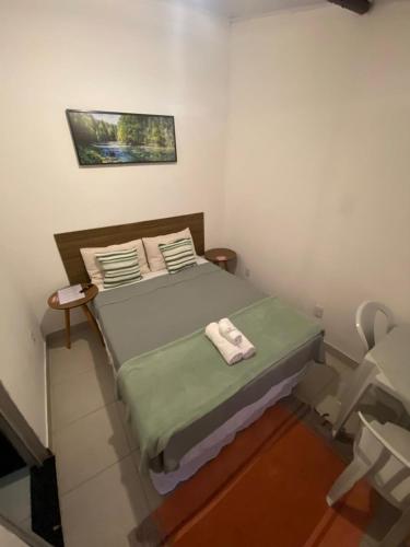 a small bedroom with a bed with towels on it at Vale do Pontal Angra Suites in Angra dos Reis