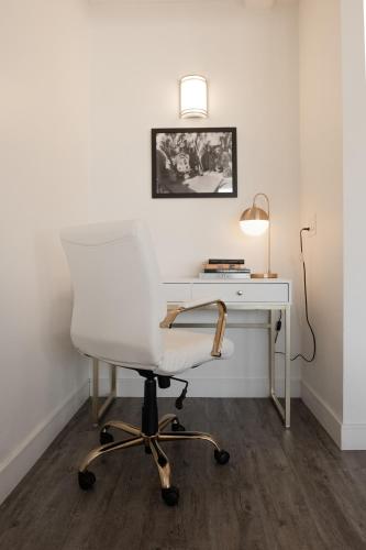 a white desk with a white chair and a lamp at Hollywood Hills Hotel in Los Angeles