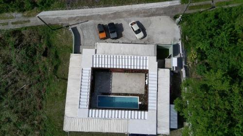 an overhead view of a parking lot with a pool at Corten Villa - A Vacation within Your Vacation in Saint Georgeʼs