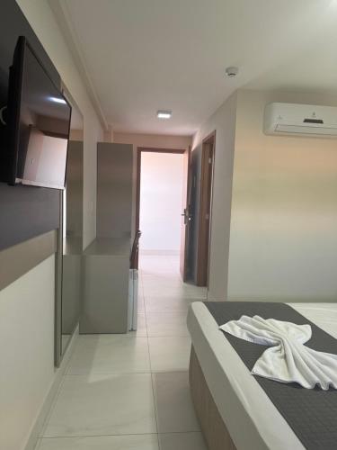 a hotel room with a bed and a kitchen at Hotel Oásis de Patos in Patos