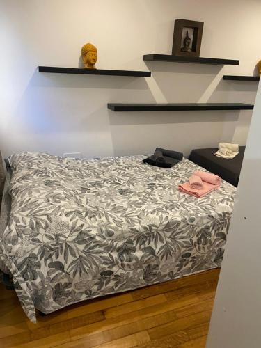 a bedroom with a bed with a gray and white comforter at Triple room in a House with a pool in Quejas