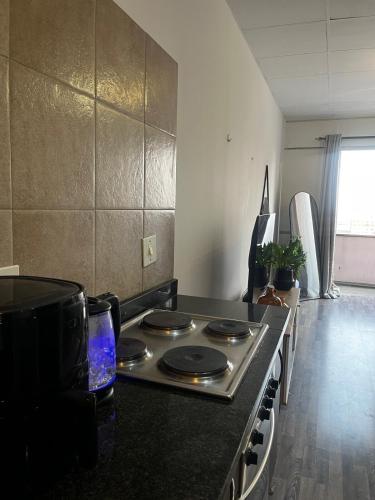 a kitchen with a stove top oven in a room at High Rise Haven in Johannesburg