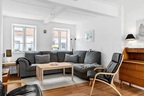 a living room with a couch and a table at 6706-Hasle-Storegade-55 in Hasle