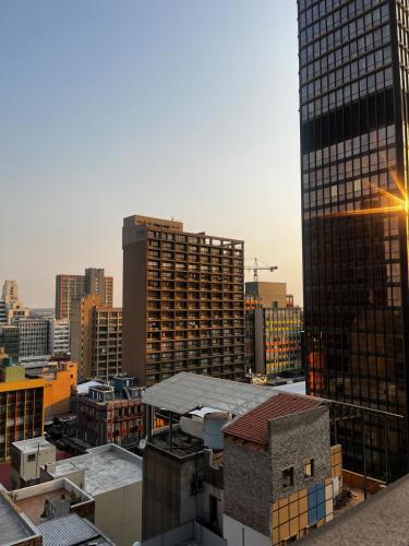 a view of a city skyline with tall buildings at High Rise Haven in Johannesburg