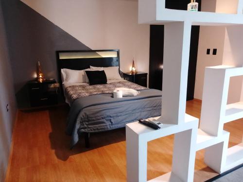 a bedroom with a bed and two night stands at Hotel Business in El Gallinero